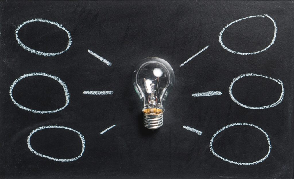 Light bulb with chalk circles coming from it