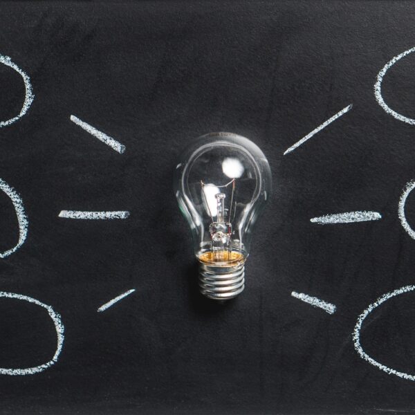 Light bulb with chalk circles coming from it